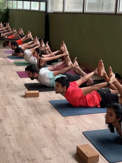 A Sunday yoga session in full flow with a synchronized bow pose. The energy of practicing together is powerful.