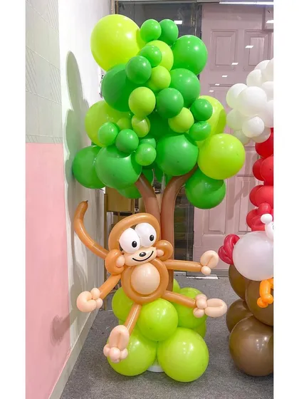 A close-up of the cheeky monkey from my farm-themed balloon sculpture. The detailed face and playful pose, hanging from a balloon tree, showcase the character and personality I put into each creation.