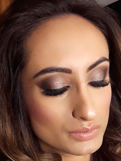 A dramatic smokey eye look with a metallic finish, perfect for an evening reception or cocktail party. The skin is kept flawless and contoured, with a soft nude lip to balance the look.