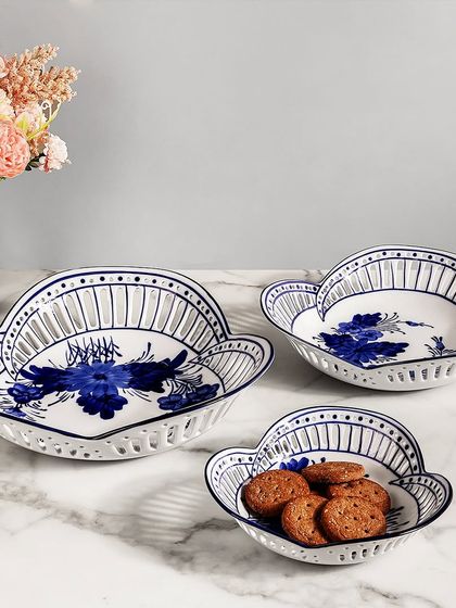 This set of three blue pottery serving bowls features delicate floral patterns and an open-work lattice design. They are perfect for serving snacks or as a decorative centerpiece on your dining or coffee table.