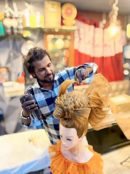Finalizing the fish tail with hairspray to ensure every strand is perfectly in place. This level of detail is what defines my work as a hair artist.