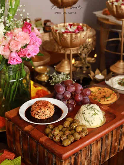 A beautifully styled cheese and dips platter from a Diwali party. The moody lighting and elegant presentation highlight the sophisticated side of festive catering.
