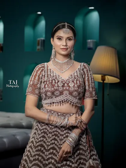 A stylish and modern bridal portrait. The bride's confident pose in her chic lehenga is perfectly captured against a contemporary interior.