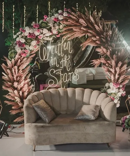 This boho-chic Sangeet seating area was a favorite. I used a plush scalloped sofa, pampas grass, and a custom neon sign to create a cozy and incredibly photogenic corner.