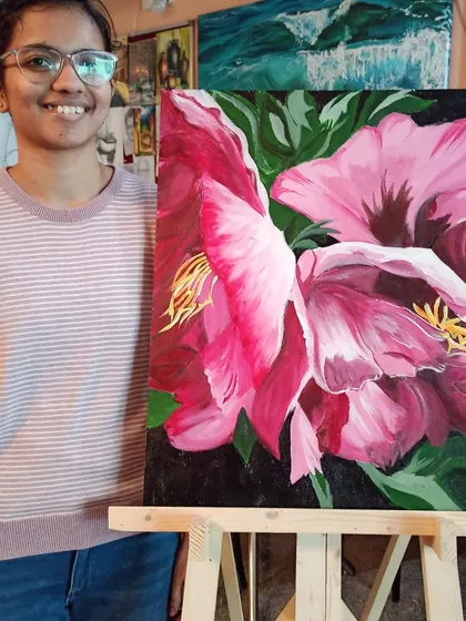 Lakshmi with her stunning large-scale floral painting. Working on a big canvas like this helps students build confidence and learn how to handle composition and color on a more impactful scale.