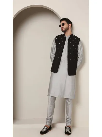 A stylish pose in the 'Shoorveer' set, complete with sunglasses. This look is for the modern man who embraces tradition with a confident, cool edge.