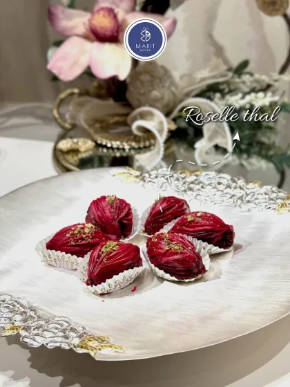 The Roselle 'thal' is a beautiful platter perfect for serving festive sweets. Here, it's shown with delicious rose-flavored treats, showcasing how my serveware enhances the presentation of food.
