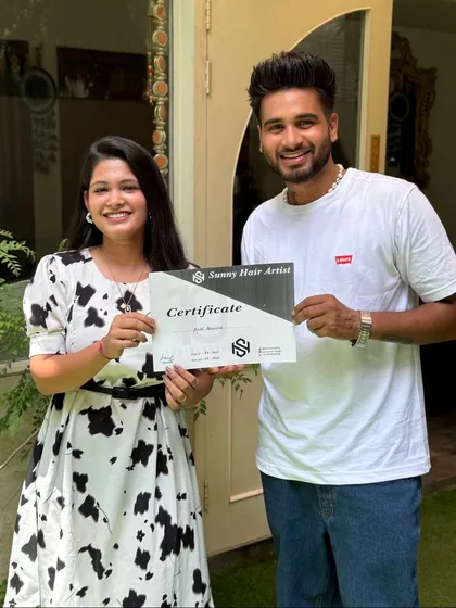A happy student holding her certificate. Seeing my students succeed is the greatest reward of my hairstyling training program.