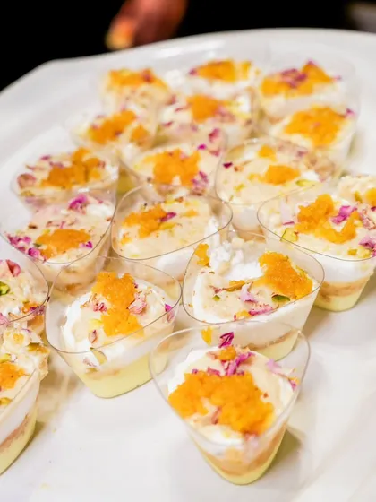 Delicate and traditional dessert shots, possibly a variation of Rasmalai or Phirni, topped with motichoor.