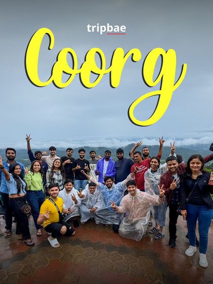 The group posing with victory signs on a viewpoint in Coorg. The camaraderie and shared joy are what make these trips special.