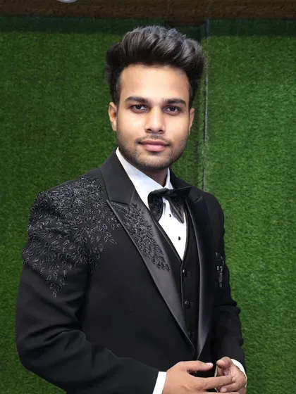 This is one of our most popular party wear tuxedos, worn by a happy customer. The highlight is the intricate sequin and bead work on the shoulders, which adds a touch of glamour to the classic black tuxedo. It's a three-piece set designed for a sharp, modern fit.