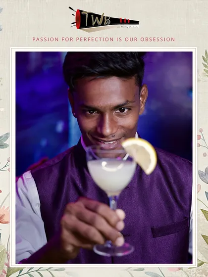 A bartender presents a classic mocktail, showcasing the professional service we provide at large-scale events like this 2000-guest reception in Pune.