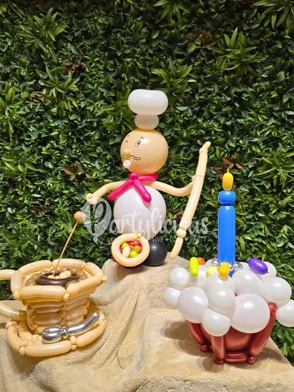 A recipe for smiles! This chef-themed balloon bouquet features a charming little chef, a cup of coffee, and a cupcake with a candle, all intricately sculpted from balloons.