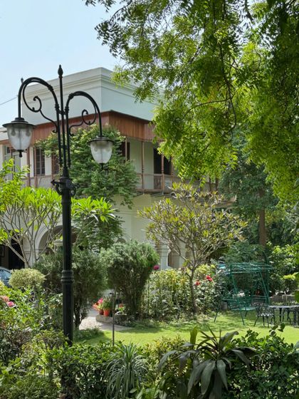 The restored bungalow seen from the garden, nestled amongst greenery, showcasing how heritage homes can be serene urban retreats.