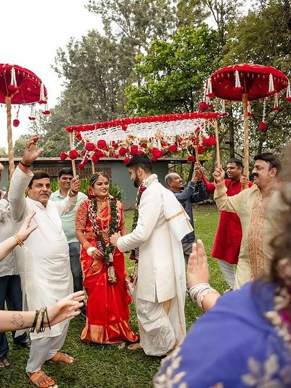The wedding procession arriving at the venue, with guests and family creating a tunnel of love and welcome.