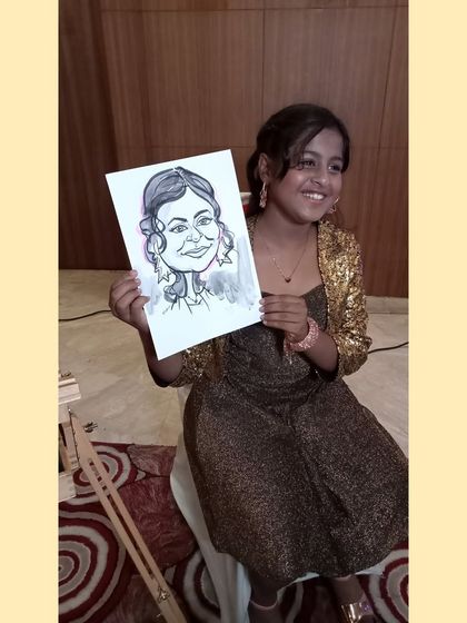 The birthday girl herself, perhaps. Her sparkling jacket is almost as bright as her smile upon seeing her caricature.