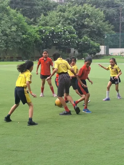 A moment of intense competition during the girls' football match, highlighting their focus and determination. We train our students to be resilient and strategic players.