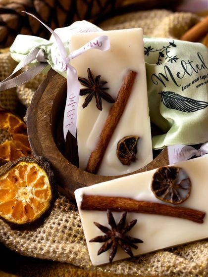 A close-up shot of the spiced wax sachets, showcasing the beautiful arrangement of natural ingredients. The earthy textures and warm tones create a cozy, autumnal atmosphere.