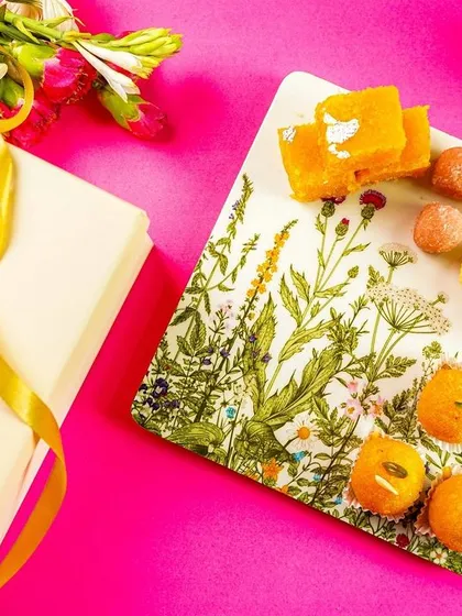 A styled shot of a gift box and a platter of sweets, perfect for promoting festive hampers.