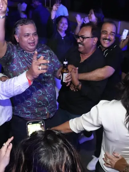 Look at those happy faces! This is what it's all about for me. A candid shot of guests completely lost in the music, hands in the air, during a private party. I live for creating this kind of pure joy.