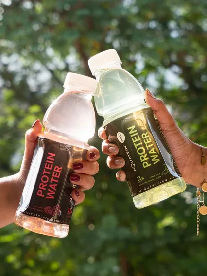 This lifestyle shot shows two people toasting with protein water bottles. It creates a sense of friendship and shared activity, positioning the drink as a great choice for a healthy, social lifestyle.