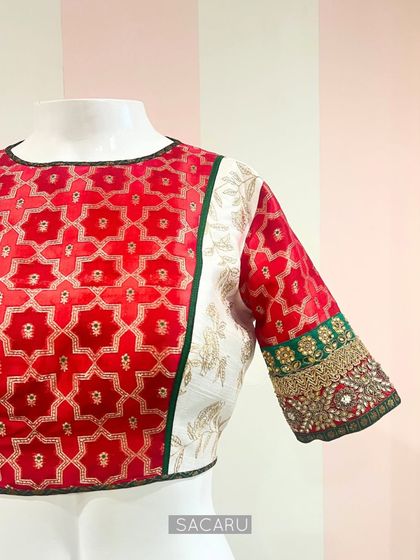 A side view of the multi-textured blouse on a mannequin, showing the different panels and the intricate sleeve work.