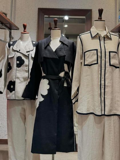 A display of modern linen outfits from Linen Bloom's 'Ruh' collection, in a classic black and white palette.