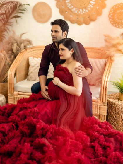 A sweet couple's portrait, with both partners sharing a quiet moment on the boho-themed set.