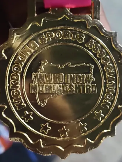 A close-up of the WAKO India Maharashtra gold medal, a symbol of the highest achievement at the state level. This is what our athletes strive for.