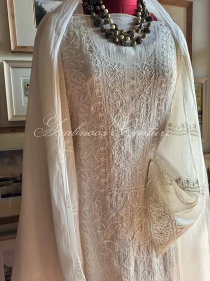 A slightly angled view of the off-white kurta, showing the texture of the hand-embroidery and the drape of the fabric.