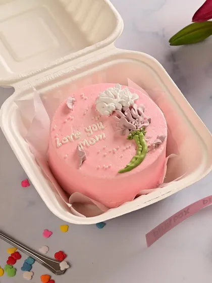 Another one of our popular Mother's Day bento cakes, with a "Love you Mom" message and a beautiful floral design.