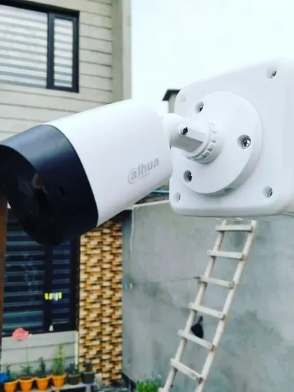 A Dahua bullet camera installed outside a building. Dahua is another top brand we supply, known for its high-quality and durable security products.