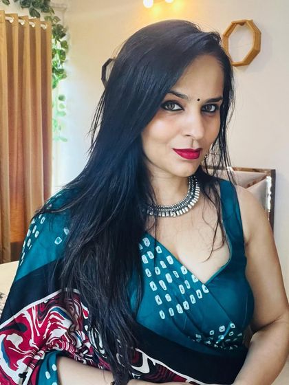 A close-up of the teal printed saree, showing the drape around the shoulders and the custom-fit blouse. This demonstrates how I tailor each piece to be flattering and comfortable for the wearer.