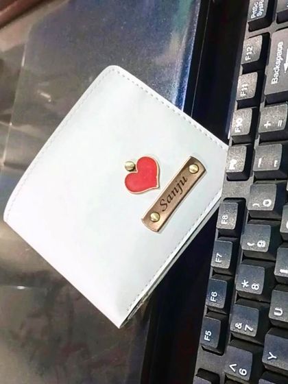 On special request from a customer, I created this beautiful white wallet with a red heart charm and an engraved nameplate.