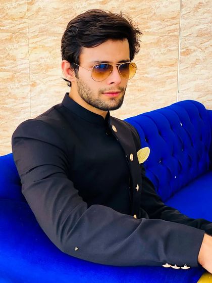 A relaxed yet stylish pose. This groom looks comfortable and confident in his reception attire.