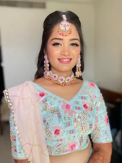 Pooja blossomed into a beautiful flower for her mehendi. The look is bright, colorful, and full of joy.