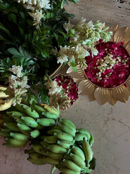 An overhead shot of the offerings, with fresh flowers and bananas ready for the puja.