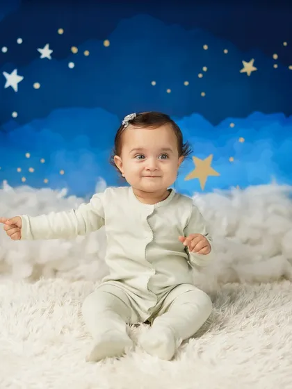 A playful moment as the baby points to something off-camera. These candid shots show off her curious and interactive nature.