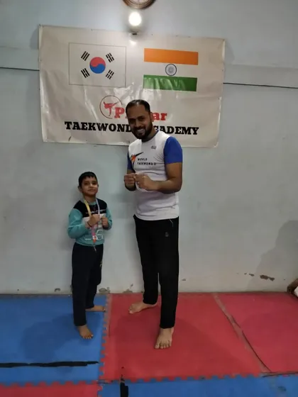 Celebrating with one of our youngest medalists at the academy after the Stairs Outer District Championship.