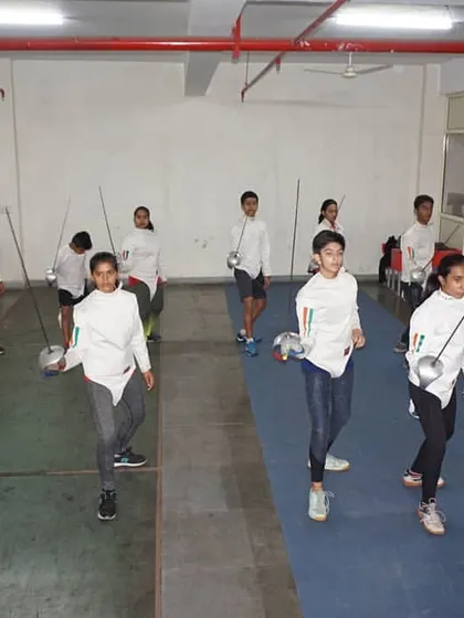 Students practicing forward and backward steps on the piste. Mastering fencing footwork is the foundation upon which all other skills are built.