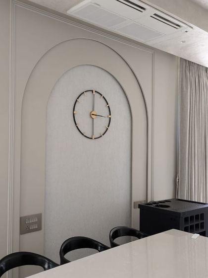 An arched wall niche with a minimalist clock, part of our Lonavala bungalow project. This detail shows how we use simple architectural forms and clean lines to create points of interest within a space.