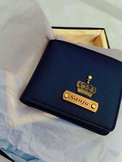 A beautiful shot of a personalized blue leather wallet for 'Sanju', nestled in its gift box.