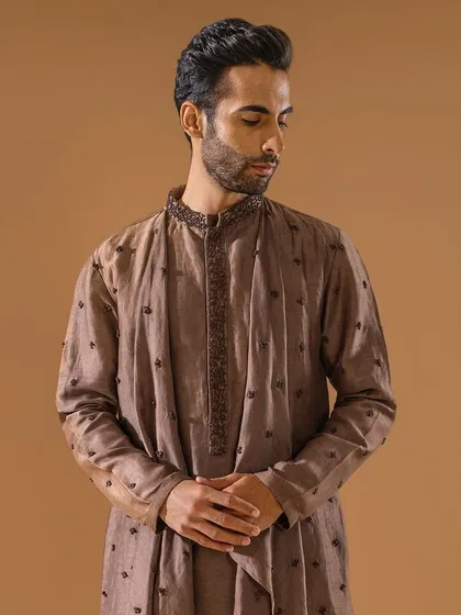 A closer look at the draped brown kurta, focusing on the embroidered collar and the unique silhouette. A perfect blend of tradition and trend.