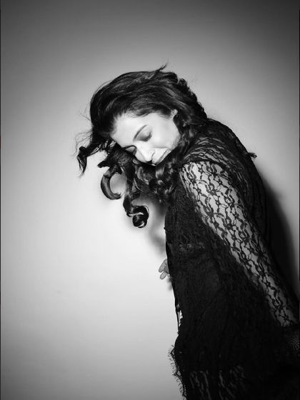 A quiet, downward glance captured in black and white. This intimate portrait is soft, emotional, and full of grace.