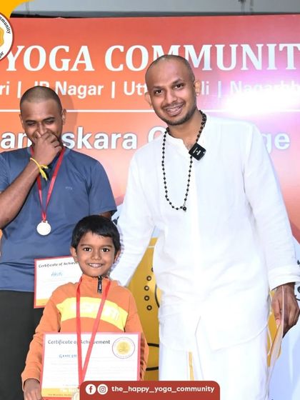 A young participant proudly receives his certificate. We believe yoga is for all ages, and it's wonderful to see the next generation embrace the practice.