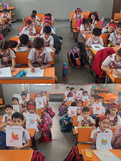 A classroom view at Gayatri Public School during the 2024 Olympiad, with younger students proudly showing their completed coloring sheets.