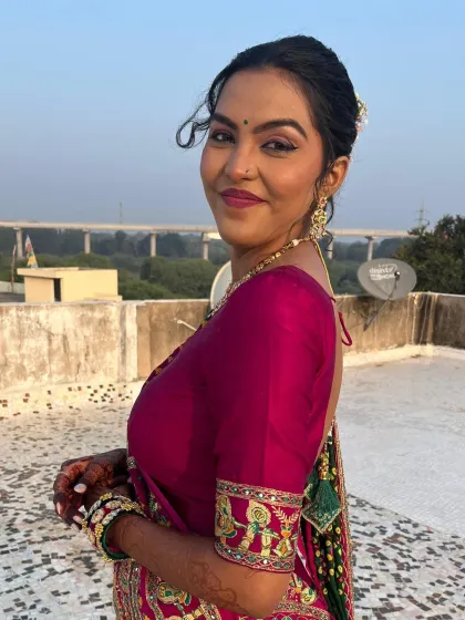 A smiling portrait of the client, her makeup looking flawless and natural.