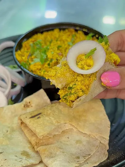 A bite of my Paneer Bhurji with Roti, showing the delicious texture of the dish. It's a perfect combination of flavours.