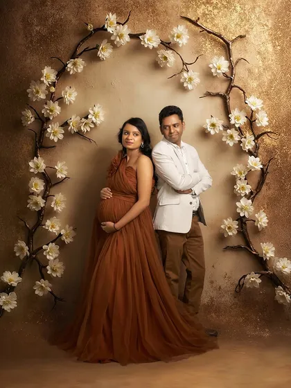 A stylish couple's portrait in our studio. The Copper gown and the partner's coordinated outfit create a cohesive and fashionable look.