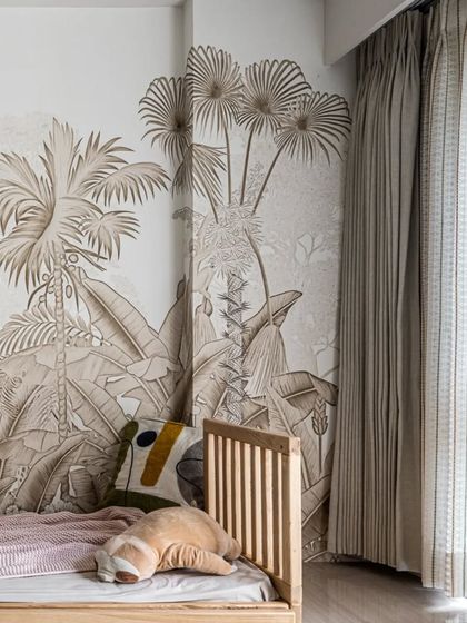 The jungle-themed wallpaper in the kids' room creates a beautiful, immersive backdrop for the custom wooden bed and playful decor.